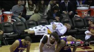 With half of the Lakers' roster put out action by injuries, there's space on the bench for center Chris Kaman to lie down and have a chat with a member of the team's training staff, Dr. Judy Seto (photo taken from LakersNation.com)